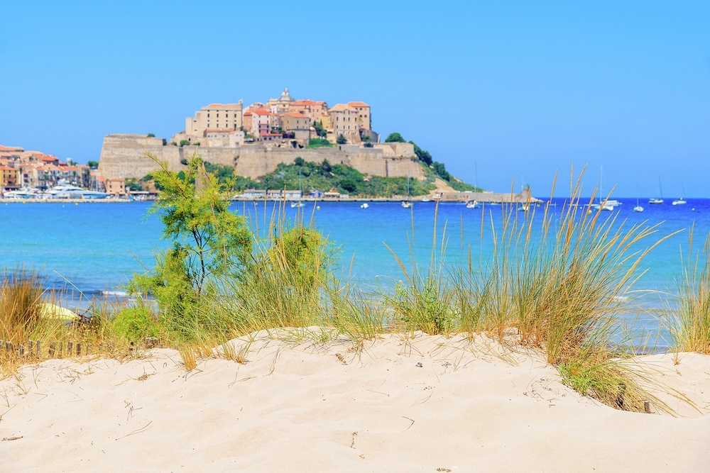 An arc of fine sand overlooked by Calvi's 12th century citadel