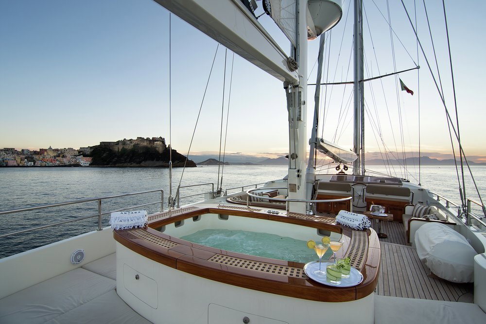 Looking forward on the flybridge, from a swathe of sunpads around the jacuzzi, the sun lounge forward of the mizzen and the helm station