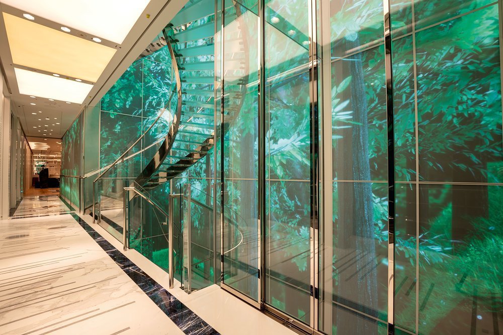 A huge interactive video wall extends up five decks