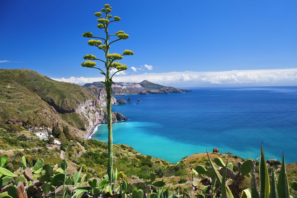 Tucked away at the foot of volcanic cliffs, the best way to reach the beach is by sea